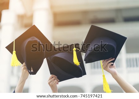 Happy new graduate students show their graduation cap in the air to celebrate their graduation with friends. Received the award certificate from university, college or campus and make them confident. Royalty-Free Stock Photo #745197421