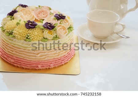 Flower cake on white background and afternoon tea set