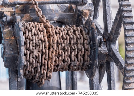 Old pulley with a rusty chain