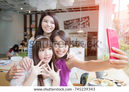 woman friends smile and selfie in restaurant