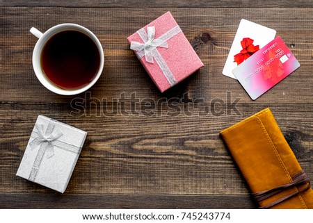 Online payment for christmas present with credit card and device on wooden background top view copspace