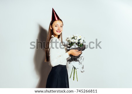 cute funny funny girl holding a bouquet of white flowers and smiling