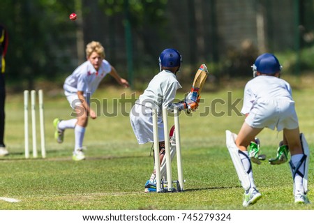 Cricket Juniors Bowler Ball Batsman 
Cricket junior game teenager player bowler action red ball batsman unidentified action 
