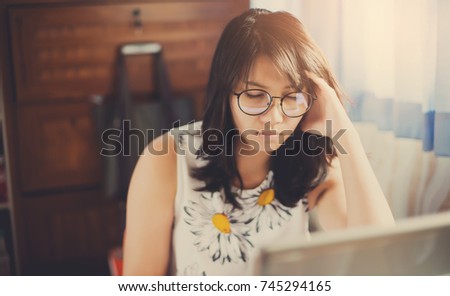 Serious beautiful woman  looking at laptop computer on table. thinking new project. working hard. headache

