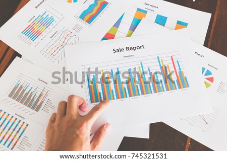 Financial graphs and charts on wooden table