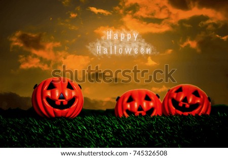 Halloween with orange pumpkin on green grass mound