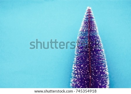 christmas tree in the snow on blue background