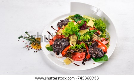 Beef Salad and Fresh Vegetables. On a wooden surface. Top view. Free space for your text.