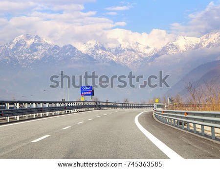 Road sign with indication to go lake Como in Italy. Traffic on highway in the Italian Alps