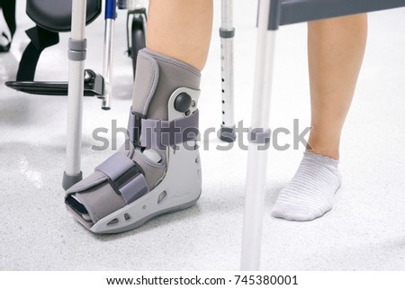 Orthopaedic Boot and crutch to a Patient.