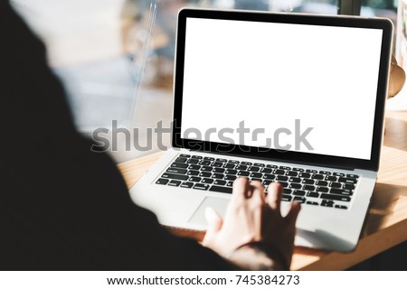 Young man working on his laptop with blank copy space screen for your advertising text message in office, Back view of business man hands busy using laptop at office desk Royalty-Free Stock Photo #745384273