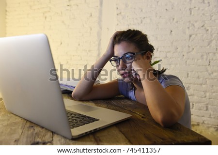 young student girl studying late night  tired at home laptop computer preparing exam exhausted and frustrated feeling stress and bored lying lazy on desk in lifestyle and education concept