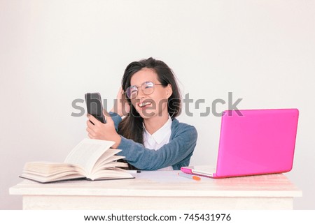 Young asian business woman wearing glasses talking on phone with copy space background - Vintage Light Effect added 

