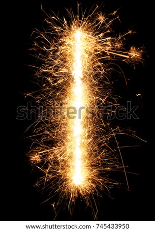 Sparkler firework light alphabet I isolated on black background