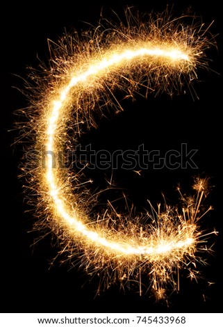 Sparkler firework light alphabet C isolated on black background