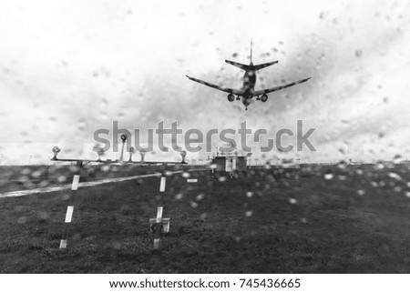 The plane lands at the airport in bad weather the view through the glass