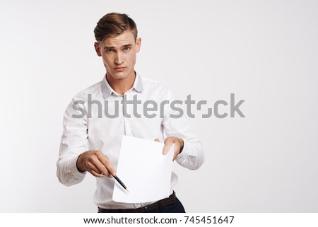 business man with documents looking at the camera on a light background                               