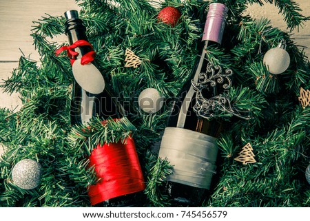 Photo of spruce branches with two bottles of wine, blank greeting card