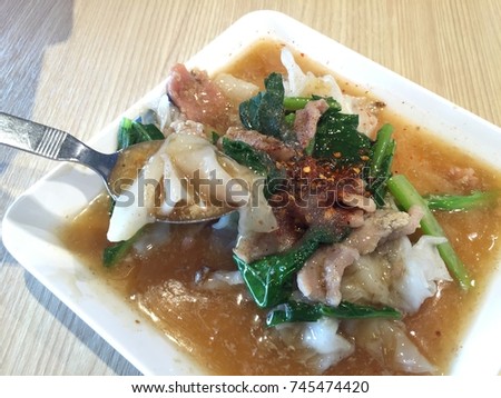Rat-na,white noodle and pork in Thai-Chinese style food on background