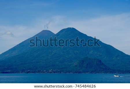 Morning sun at Lake of Atitlan,  blue skys and water, most magic lake of the planet with volcanos and indigenous people, 