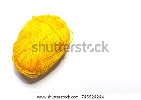 Yarn balls of different colors for knitting on a white background.