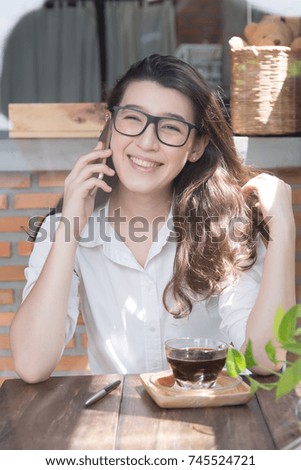 young business woman cheerful smile sitting at terrace cafe, enjoying online communication using free wireless internet connection on her web-enabled smart phone