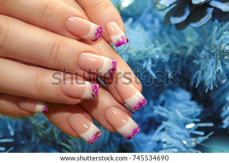 Christmas winter design French manicure with pink sequins at the end of the nails.