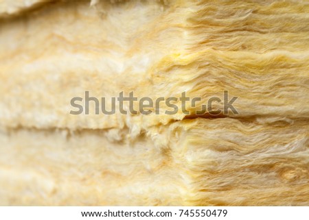 Mineral wool (or mineral fiber, mineral cotton, mineral fibre, glass wool, MMMF, MMVF) fiber thermal insulation close-up Royalty-Free Stock Photo #745550479