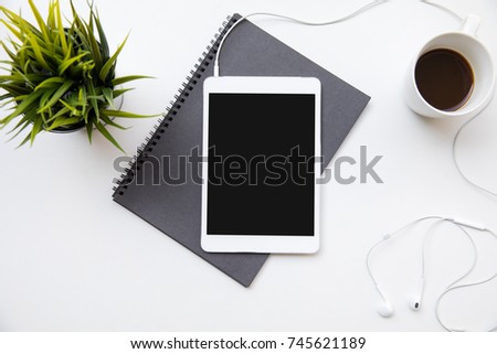 Desk table top overhead work space design layout center tablet isolated use earphone listen music and drink coffee in holiday at indoor home