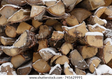 firewood snow covered wood in winter