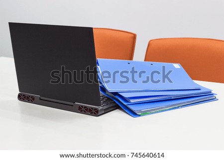 File Folder and Notebook on a white table in meeting room for presentation