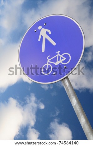 Pedestrian and biking road sign with falling perspective