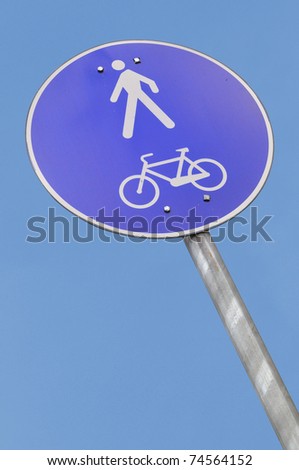 Pedestrian and biking road sign with falling perspective