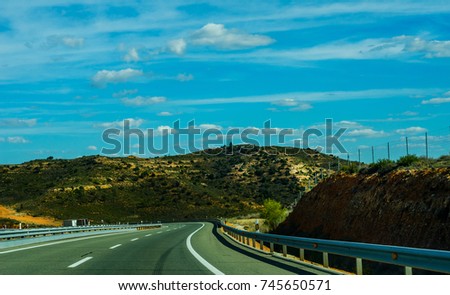Fast road in the mountains in Spain, beautiful landscape of mountains, dry earth and rock from the sun, transportation
