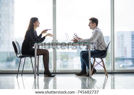 Businessman And Businesswoman Meeting In Modern Office Royalty-Free Stock Photo #745682737