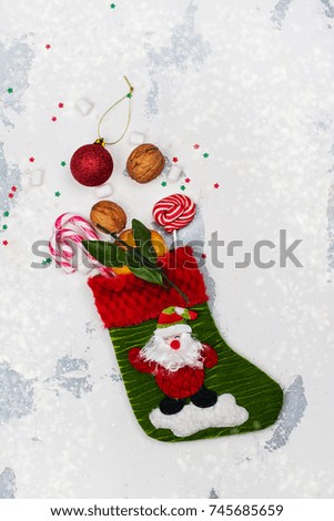 Christmas sock full of holiday gifts and sweets. Xmas greeting card. Copy space