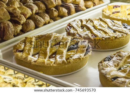 Greek jam tart (Pasta flora) on window display at a bakery.  Royalty-Free Stock Photo #745693570