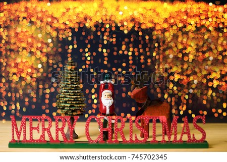 Merry Christmas.Santa Claus standing and raised hands yoga style in the golden bokeh background with reindeer and christmas tree.