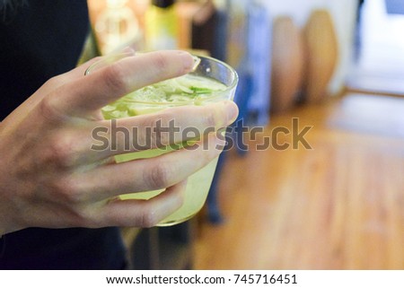 Woman hand holding Brazilian caipirinha drink