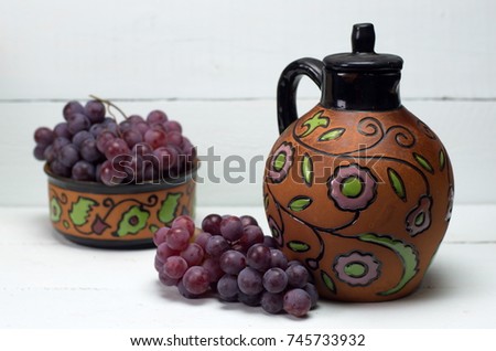Antique wine jug and grapes
