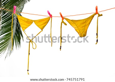 Bikini hanging on rope in sunlight 