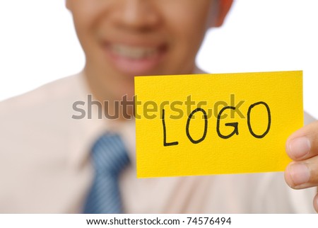 Logo words on yellow card holding by business man, closeup image.