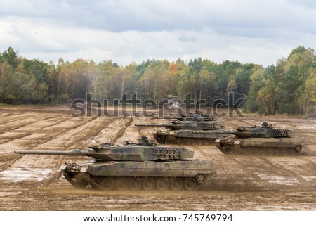 german main battle tanks drives on battlefield  Royalty-Free Stock Photo #745769794
