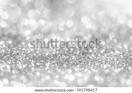 Abstract of Bright and sparkling bokeh background. silver and diamond dust bokeh blurred lighting from glitter texture . Royalty-Free Stock Photo #745798417