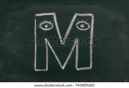 Letter M on chalkboard, blackboard texture