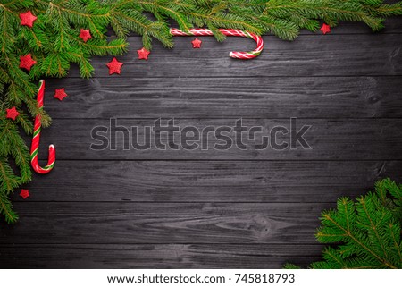 Christmas fir tree on black wooden grunge background