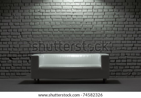 white modern leather sofa and brick background