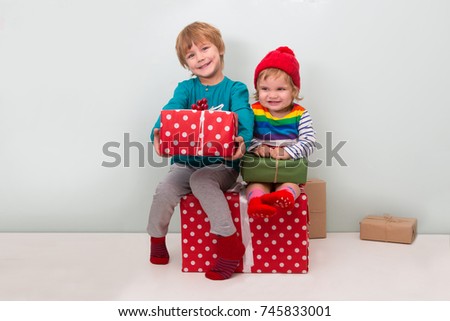 two happy children with  Christmas presents and decoration