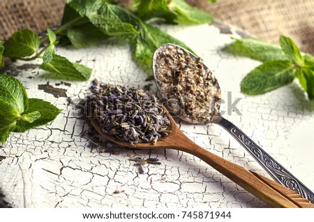 Dried lavender, lavender salt in wooden spoons and fresh mint leaves. Rustic and shabby chic style. Preparing for cooking Royalty-Free Stock Photo #745871944