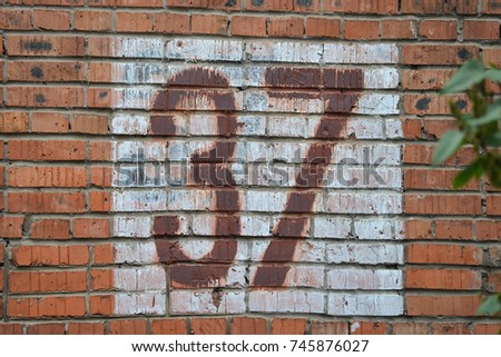 Old home number, 37, at the brick wall. Thirty seven.